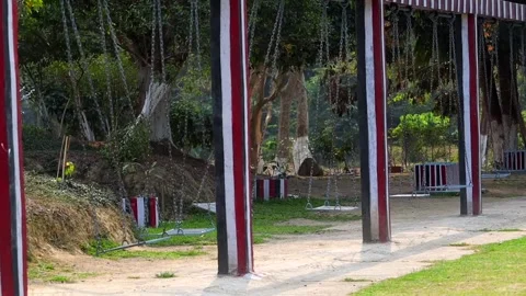 Close view of empty park swings with striped pillars Stock Footage 332611751