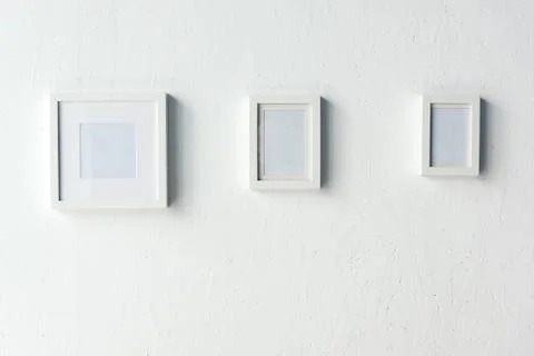 Close up view of empty photo frames hanging on wall Stock Photos