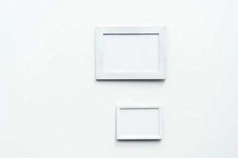 Close up view of empty photo frames hanging on wall Foto stock
