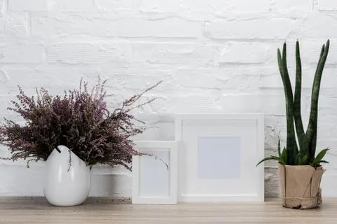 Close up view of empty photo frames and flowers on wooden tabletop 写真素材