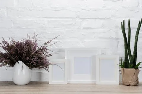Close up view of empty photo frames and flowers on tabletop 写真素材