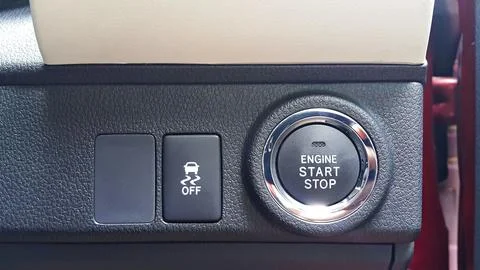 Close up view of engine start stop button and traction control button. Stock Photos