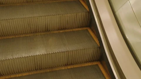 Close up view of escalator steps with yellow safety boundaries in modern buildin 動画素材 344100985