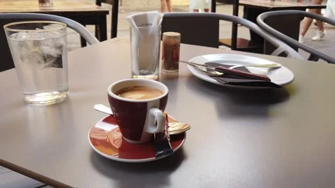 Close Up View of Espresso Coffee and Ice Water on Outdoor Café Terrace Table Stock Footage 337936139