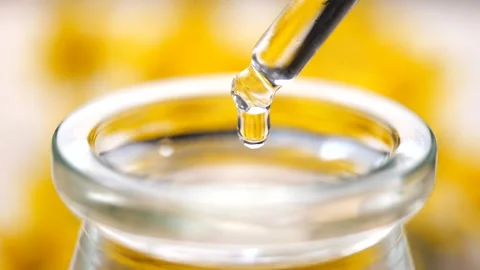 Close up view of essential oil falling from glass dropper in slow motion Video stock 151615322