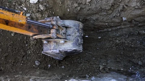 Up close view of excavator digging into the ground Stock Footage 121447783