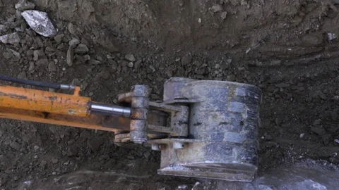 Up close view of excavator digging into the ground Stock Footage 121450612