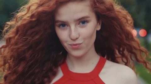 Close up view of extremely beautiful ginger curly girl seductively walking down Stock Footage 115669992