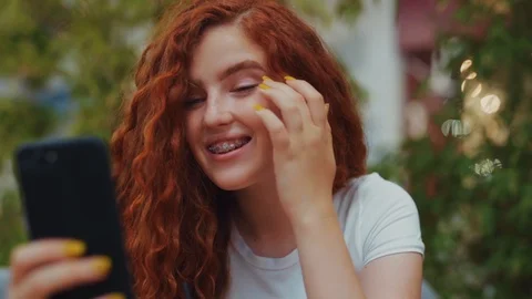 Close up view of extremely beautiful redheaded curly student girl smiling cutely Stock Footage 114250828