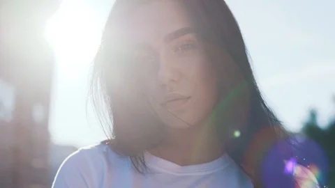 Close up view of extremely pretty young brunette woman playfully ruffling her Stock Footage 111219725