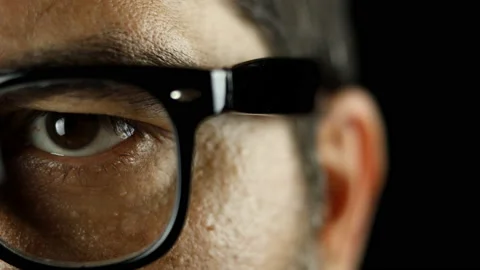 A close-up view into the eye of a man wearing eyeglasses. Stock Footage 157925815