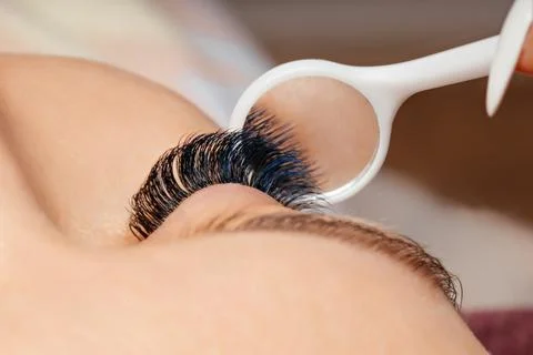 Close-up view of eyelash extension application with a technician using a ma.. Stock Photos