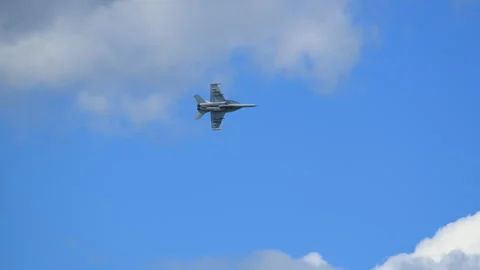 Close-up view of F-18 fighter jet at full power maneuver against a cloudy sky Stock Footage 317733309
