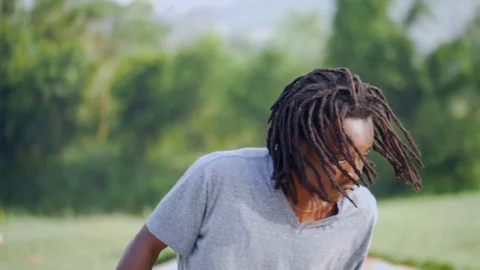 Close up view face and dreads of young boy skateboarder Stock-Footage 112984547