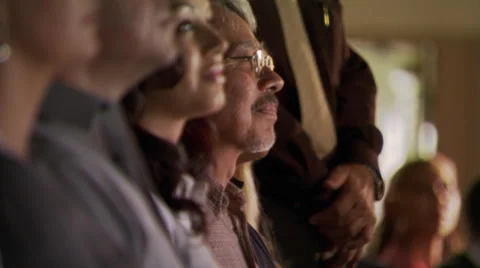 Close view of faces in a row of seated congregants listening attentively Stock Footage 59531974