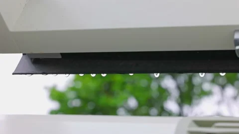 Close up view of falling raindrops from  window frame of skylight during rain. Stock Footage 197329620