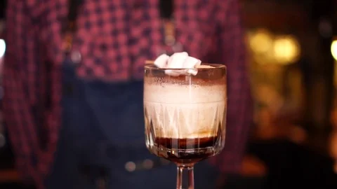 Close up view on fancy coffee flavored alcohol beverage cocktail drink with Stock Footage 103747829