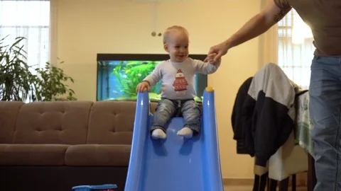 Close View Father Helps Blond Little Baby Boy On Slide Stock Footage 102870502