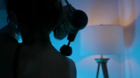 Close-up view of a female back with smoothly moving punching device over skin Stock Footage 169000453