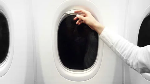 Close-up View of Female Hand Closed Airplane Window. 4K Video Clip Stock-Footage 99746778