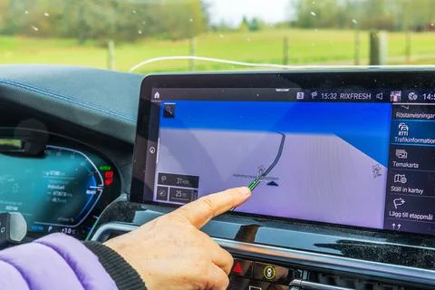 Close up view of female hand using BMW iX3 M navigation screen with digital map Stock Photos