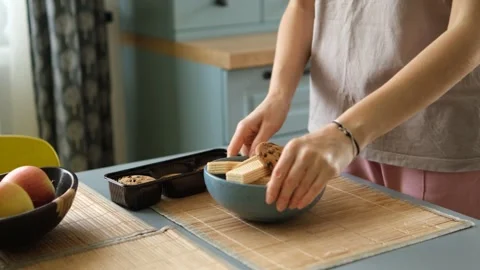 Close up view of female hands arranging a delicious snack, putting chocolate Stock Footage 340231833