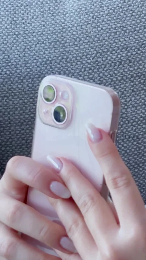 Close-up view of female hands with a fresh, elegant manicure holding and using Stock Footage 345118031