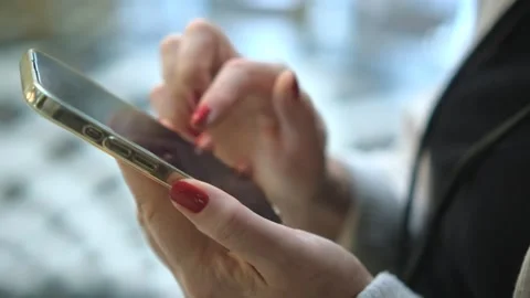 Close-up view of female hands holding smartphone, using the touchscreen 스톡 동영상 251693543