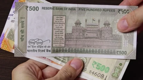 Close-up view of female hands showing Indian paper note of 500 rupees. Stock Footage 304090178