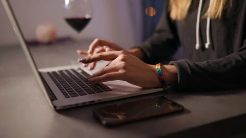 Close view of female hands typing on laptop wearing rainbw LGBT bracelet with 스톡 동영상 137611504