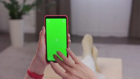 Close up view of female hands using smartphone with green mock-up screen Stock Footage 196644617