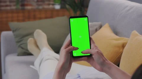 Close up view of female hands using smartphone with green mock-up screen Stock Footage 197140571
