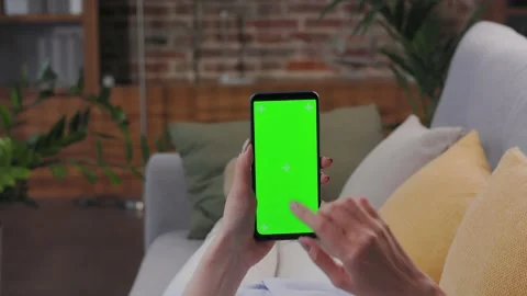 Close up view of female hands using smartphone with green mock-up screen Video stock 209698037