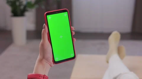Close up view of female hands using smartphone with green mock-up screen Stock Footage 246492335