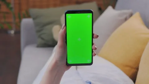 Close up view of female hands using smartphone with green mock-up screen Stock Footage 246492365