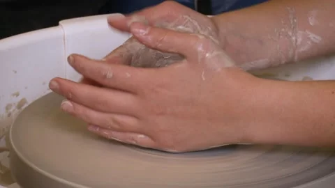 Close view of female hands working with clay on a pottery wheel. Stock Footage 133348059