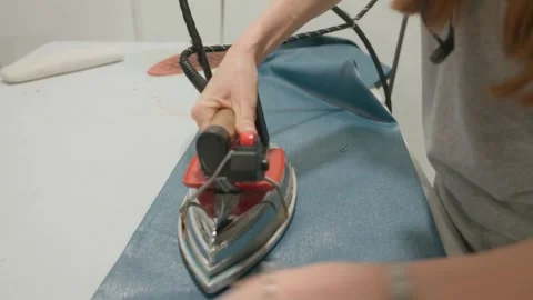 Close-up view of a female worker ironing clothes. Dry cleaner, laundry Stock Footage 284487044