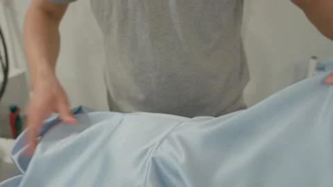 Close-up view of a female worker ironing clothes. Dry cleaner, laundry Stock Footage 284487052