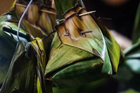 Close up view of fermented glutinous rice tape ketan wrapped in banana leaf.. Stock Photos