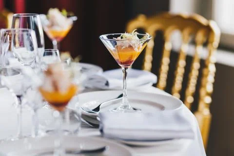 Close up view of festive decorated table with expensive cutlery, glass of alc Foto stock