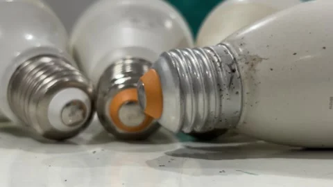 Close-up view of a few old Edison screw light bulb lying on a tabletop. Stock Footage 339321063