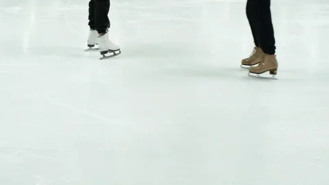 Close up view of figure skater's skating shoes on ice rink. Sliding over ice in Stock Footage 173539074