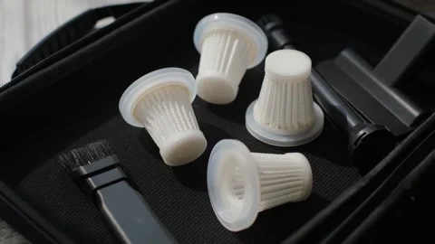 A close-up view of the filters of a compact portable car vacuum cleaner Stock Footage 317772693