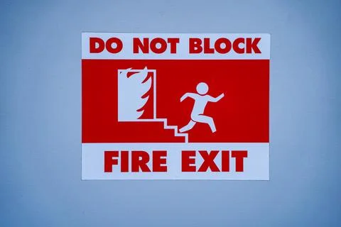 Close up view of fire exit warning sign Stock Photos