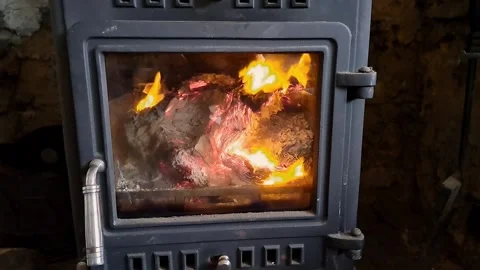 A close up view of a fire inside a stove or wood burning stove Stock-Footage 265147574