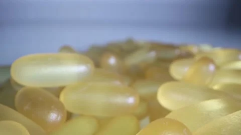 Close-up view of fish oil omega 3 liquid gel capsules Stock Footage 166403998