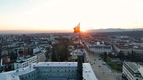 A close-up view of the flag of Bulgaria blowing in the wind against a sunset Stock Footage 331191188