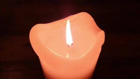 Close up view at the flame of a candle light moving slowly. Stock Footage 257551431