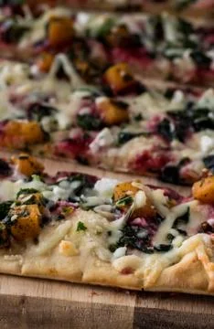 Close up view of a flat bread pizza ready for eating. Stock Photos