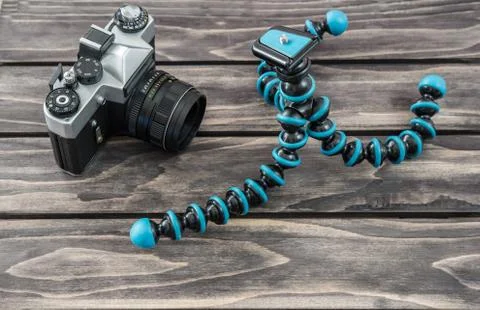 Close up view of a flexible type tripod and vintage camera Stock Photos